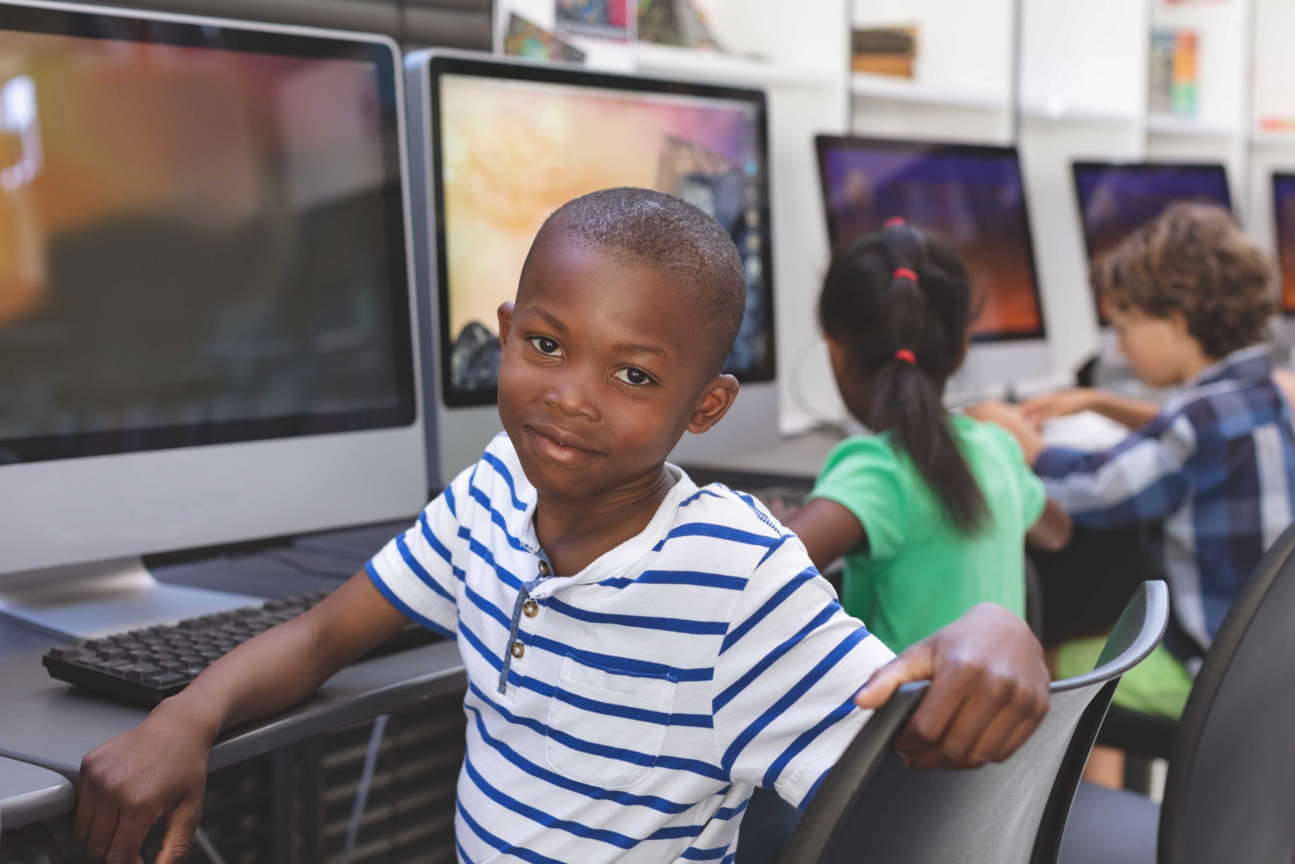 schoolboy-sitting-on-chair-over-computer